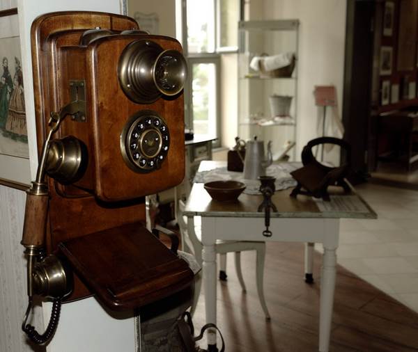 A Wooden Vintage Telephone on a Room Wall